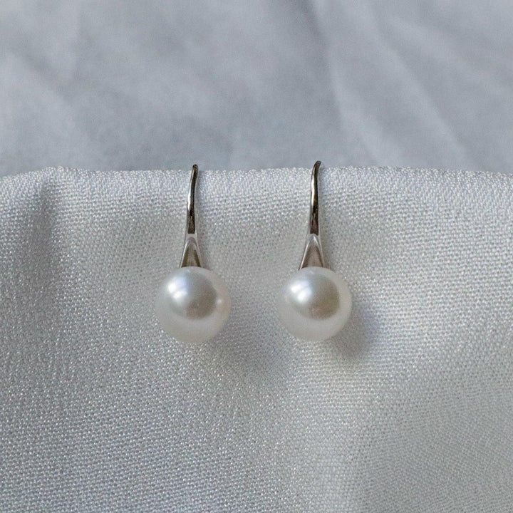 Close-up of 7mm freshwater pearl earrings with stiletto sterling silver setting, highlighting the elegance of silver pearl earrings from Pearlpals