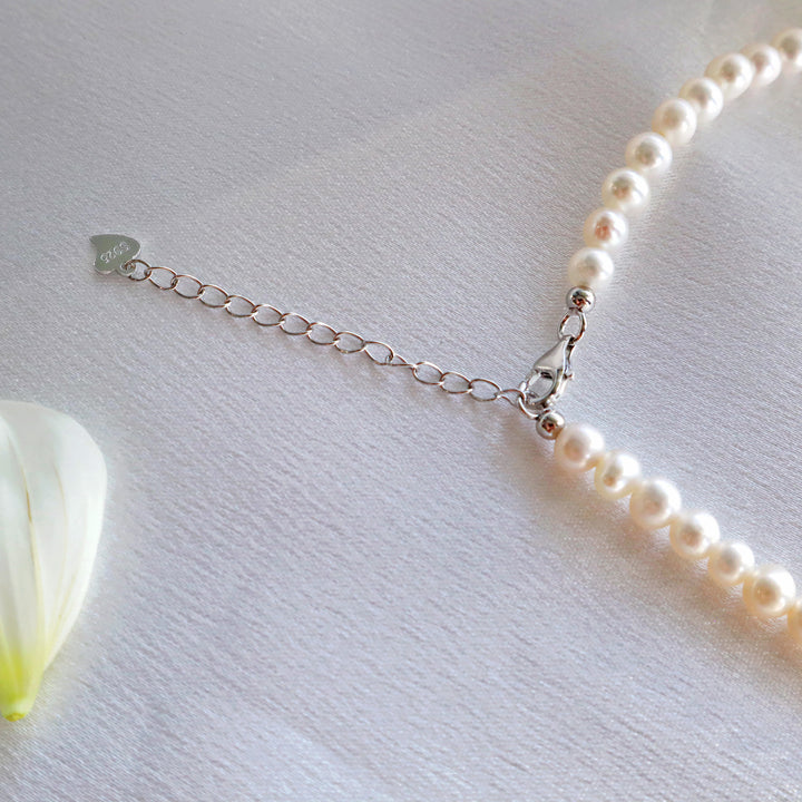 Pearlpals  S925 silver necklace extender with a seed-shaped clasp