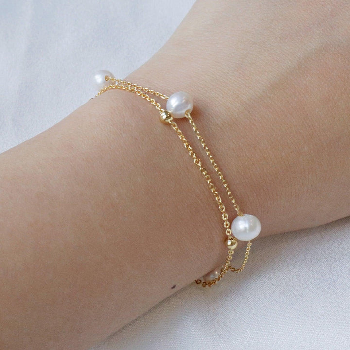 Pearlpals double chain pearl bracelet two delicate chains - one adorned with golden beads, and the other with five lustrous pearls