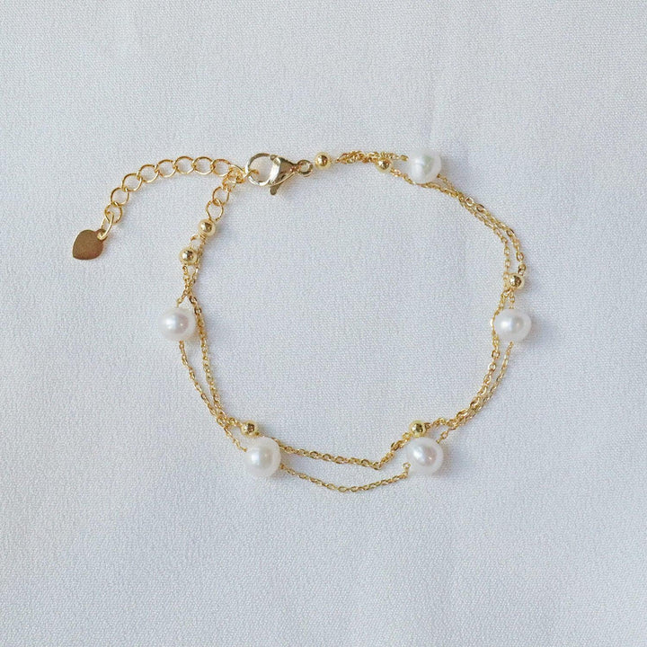 Pearlpals double chain pearl bracelet two delicate chains - one adorned with golden beads, and the other with five lustrous pearls