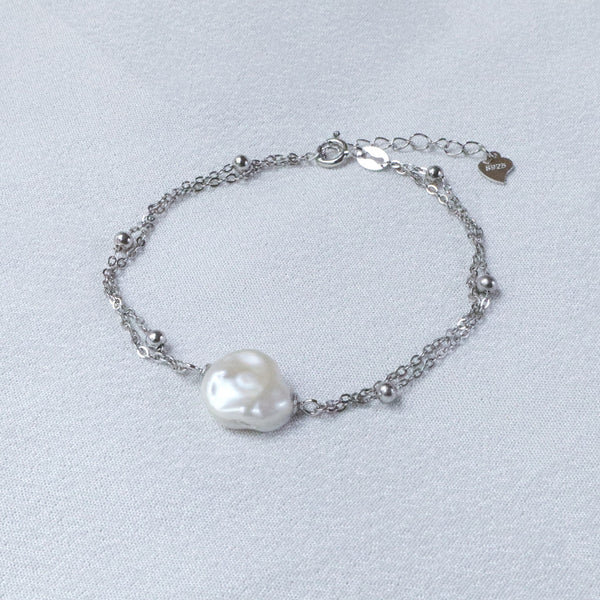 Pearlpals A silver bracelet with a baroque pearl and small silver beads.