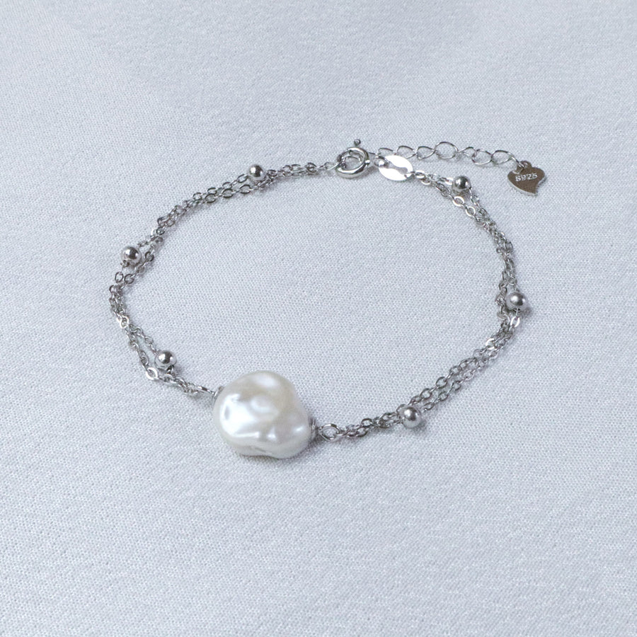 Pearlpals A silver bracelet with a baroque pearl and small silver beads.