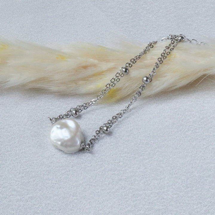 Pearlpals A silver bracelet with a baroque pearl and small silver beads.