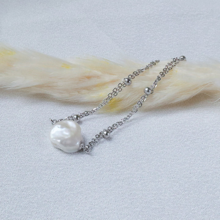 Pearlpals A silver bracelet with a baroque pearl and small silver beads.