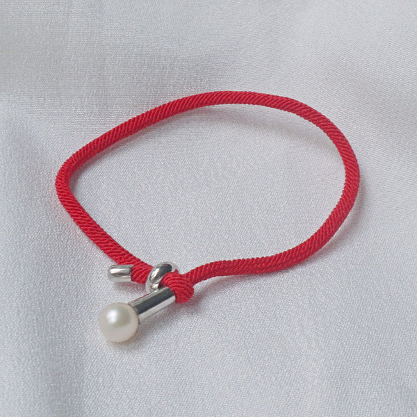 Pearlpals The 7mm freshwater Pearl Bracelet features a vibrant red rope and adjustable knot closure