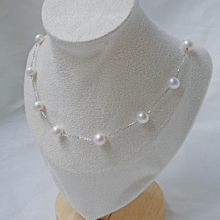 A delicate necklace featuring 7mm AA-grade pearls evenly spaced along a fine sterling silver chainlower for decoration.