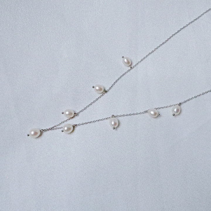 Pearlpals A sterling silver necklace with pearls evenly spaced along a delicate chain, 