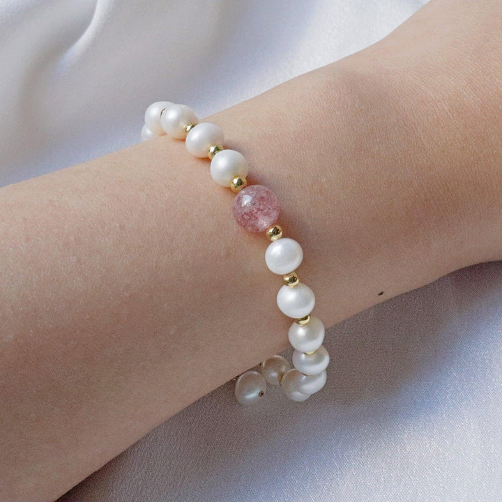 PearlpalsA gold-plated bracelet with pearls and gold beads, featuring a central strawberry quartz bead