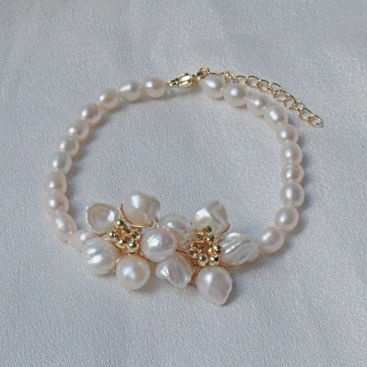 Pearlpals A gold-plated pearl bracelet featuring baroque pearls with a floral centerpiece made of petal-shaped pearls