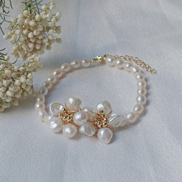 Pearlpals A gold-plated pearl bracelet featuring baroque pearls with a floral centerpiece made of petal-shaped pearls