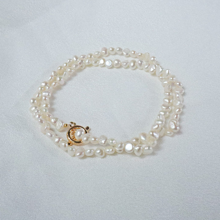 Gold-plated necklace with unique stone-shaped pearls and a gold OT clasp