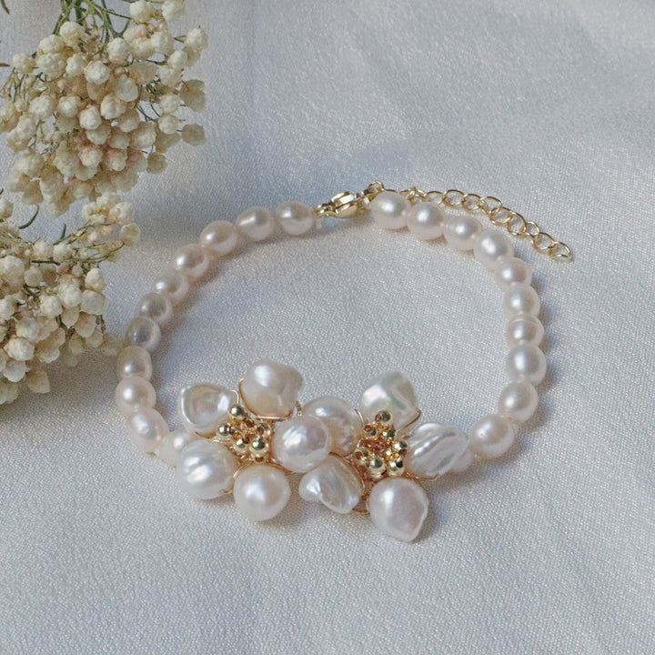 Pearlpals A gold-plated pearl bracelet featuring baroque pearls with a floral centerpiece made of petal-shaped pearls