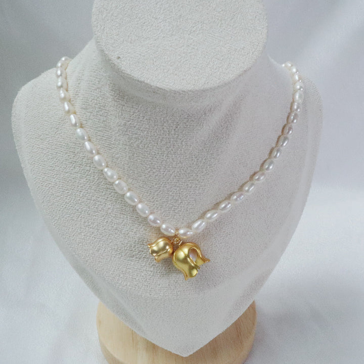 Gold-plated pearl necklace with two gold lily of the valley charms, each containing a pearl